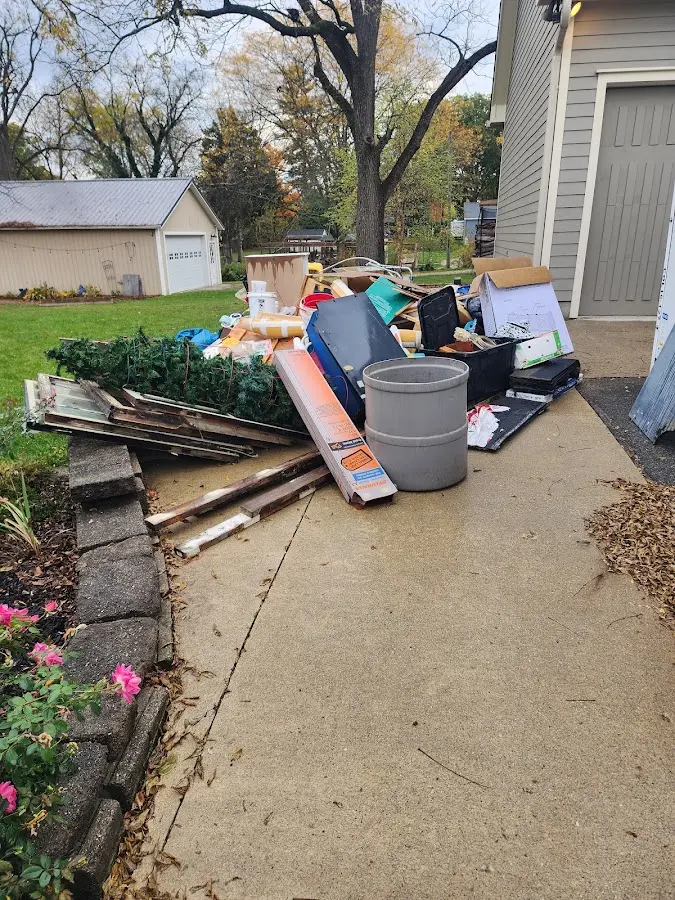 Dumpster being loaded with debris for 12 Yard Dumpster Rental in Fort Wayne